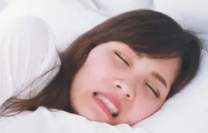 Woman grinding teeth at night, a case for the Smilezone dentist.
