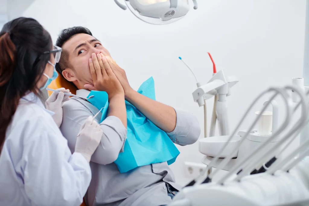 Anxious patient receiving comfortable dental treatment at Smilezone practice in Zug.
